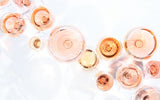 Many glasses of rose wine at wine tasting. Concept of rose wine and variety