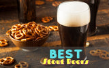 A glass of dark stout beer with pretzels in the background