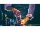 A bartender opening a cocktail shaker