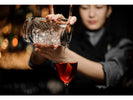 Bartender using a cocktail strainer