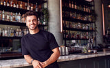 A bar owner smiling and looking at the camera