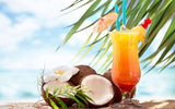 A glass of tequila sunrise on the beach