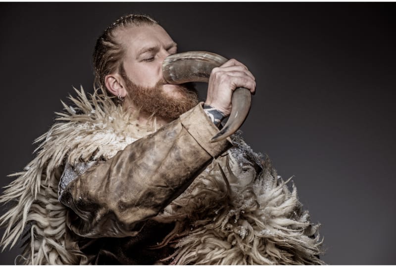 Portrait of a Viking warrior drinking mead from a horn